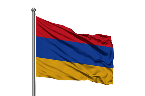 Waving Armenia flag with red, blue, and orange horizontal stripes on a flagpole